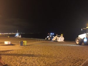 The Barcelona Beach at night. Night time was the right time for beach maintenance.