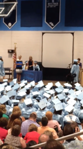 Psychiatric Service Dog Hank hears the accolades of the crowd while he walks up the steps during his recipient's high school graduation.