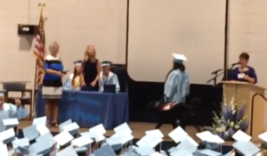Psychiatric Service Dog Hank accompanies his teenage recipient during her high school graduation ceremony.