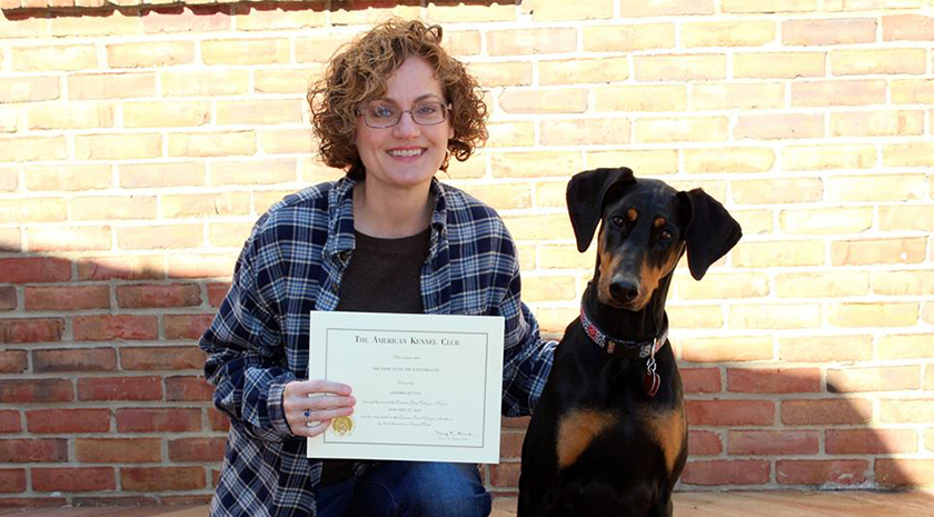 Woman Holding A Dog Training Certificate